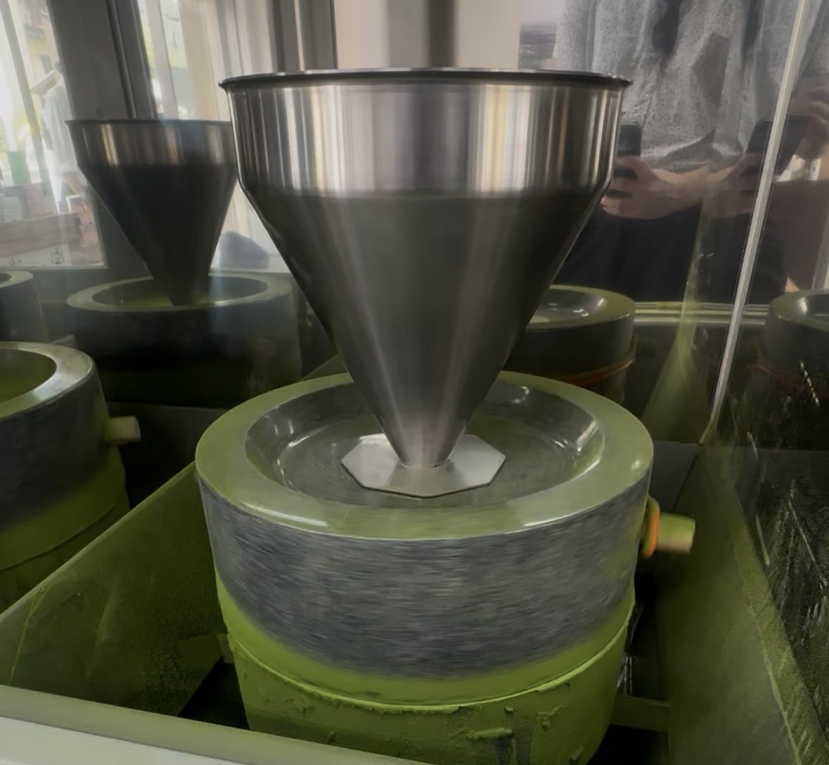 Stone granite mills grinding tencha into ceremonial matcha powder, Uji, Kyoto